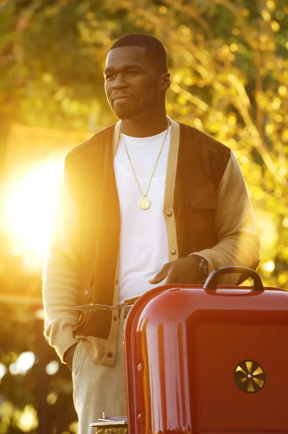 Editorial portrait of a musician with red luggage at sunset