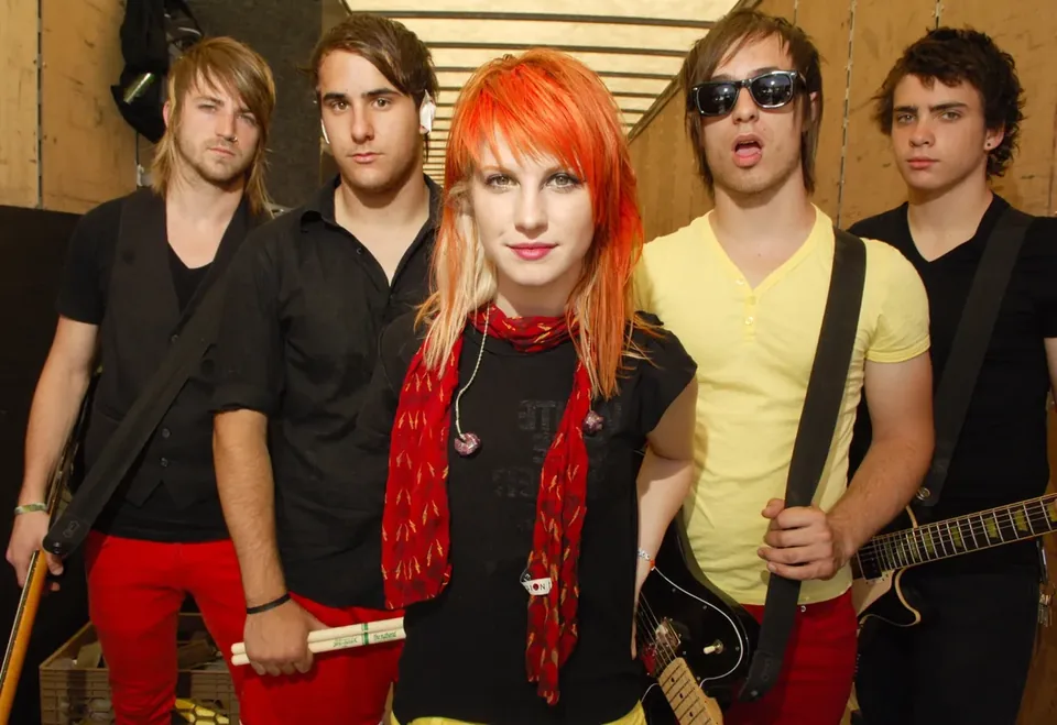 Band portrait with a red-haired lead singer and four band members