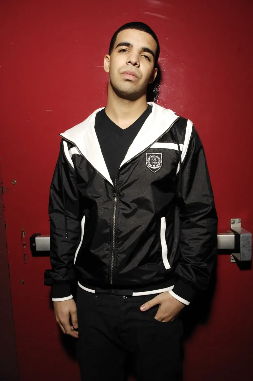 Studio portrait of a musician against a red backdrop
