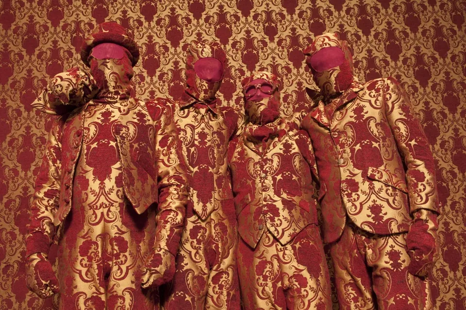 Editorial group portrait in ornate red-and-gold costumes